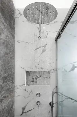 a shower in a bathroom with marble walls at Florant in Athens