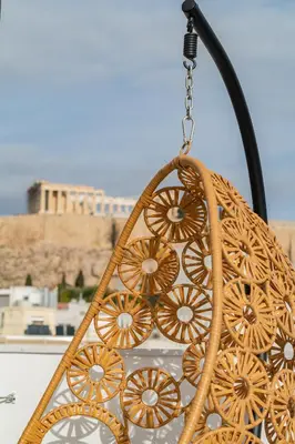 a chandelier hanging from a chain in front of a building at The Minion Elegant Suite - Acropolis View in Athens