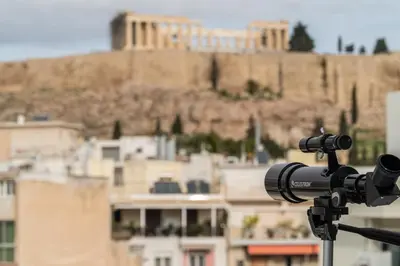 a camera on a tripod with a building in the background at The Minion Elegant Suite - Acropolis View in Athens