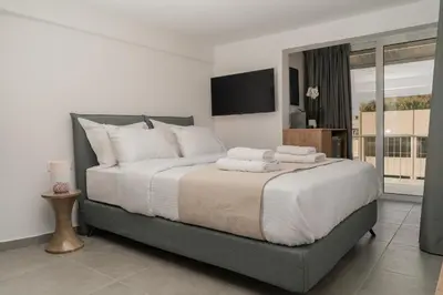 a bedroom with a large bed with towels on it at The Minion Elegant Suite - Acropolis View in Athens