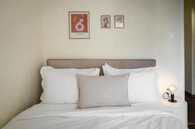 a bed with white sheets and pillows in a bedroom at Home1 in Athens