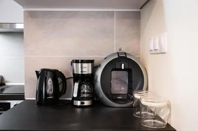 a kitchen counter with a coffee maker and a blender at Home1 in Athens