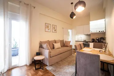 a living room with a couch and a table at Home1 in Athens