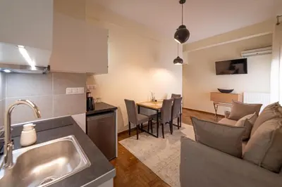 a kitchen and living room with a couch and a table at Home1 in Athens