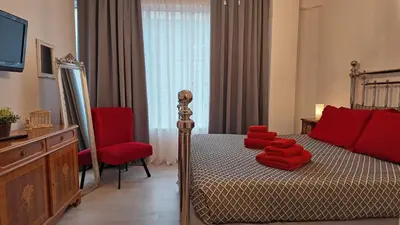 a bedroom with a bed with red pillows on it at Athens Point Hotel Monastiraki in Athens