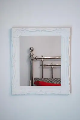 a mirror with a white frame on a wall at Athens Point Hotel Monastiraki in Athens