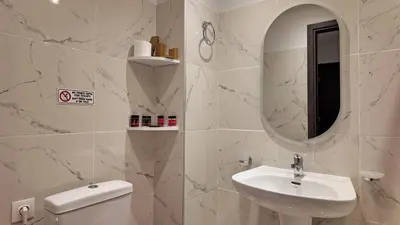 a bathroom with a sink and a toilet and a mirror at Athens Point Hotel Monastiraki in Athens