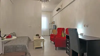a living room with red chairs and a table at Athens Point Hotel Monastiraki in Athens
