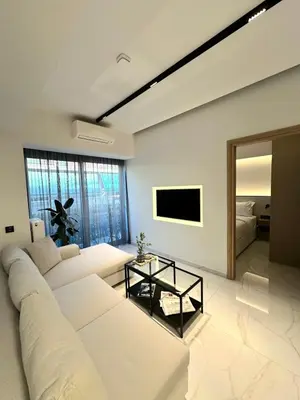 a living room with a white couch and a television at Nidus Boutique Apartment in Athens