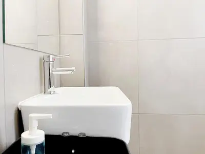 a white bathroom with a sink and a mirror at Calliope Suite 4 with Acropolis rooftop access in Athens