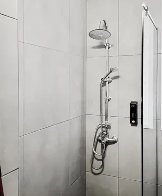 a shower with a shower head in a bathroom at Calliope Suite 4 with Acropolis rooftop access in Athens