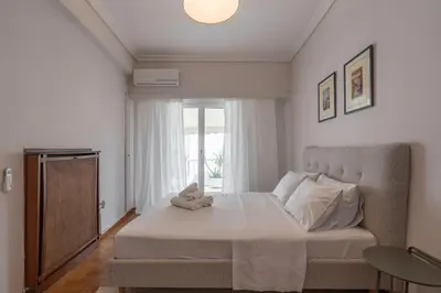a bedroom with a large bed with a window at Maison Terrasse - Georgeous 3Br Apt next to Acropolis in Athens