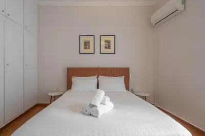 a bedroom with a white bed with towels on it at Maison Terrasse - Georgeous 3Br Apt next to Acropolis in Athens