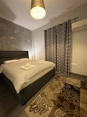 a bedroom with a large bed and a rug at Athens comfy apartment in Athens
