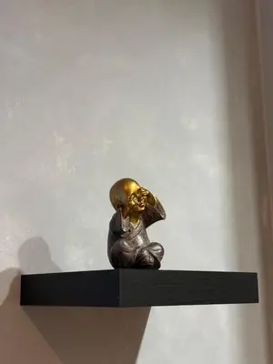 a bronze statue of a dog sitting on a shelf at Athens comfy apartment in Athens