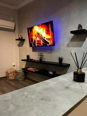 a living room with a flat screen tv on a wall at Athens comfy apartment in Athens