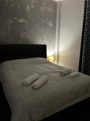 a bed with two pillows on top of it at Athens comfy apartment in Athens
