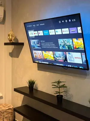 a flat screen tv hanging on a wall at Athens comfy apartment in Athens