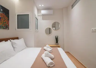 a bedroom with a bed with towels on it at Vibrant Pagrati 2-BD Retreat with Elegant-Modern style in Athens
