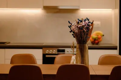a vase of flowers sitting on a table in a kitchen at Vibrant Pagrati 2-BD Retreat with Elegant-Modern style in Athens