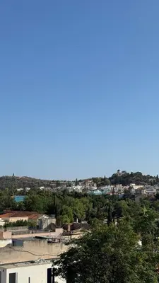 a view of a city with trees and buildings at The Green Parthenon in Athens