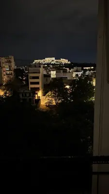 a view of a city at night with buildings at The Green Parthenon in Athens