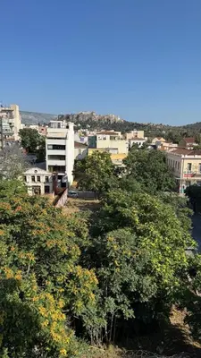 a view of a city with trees and buildings at The Green Parthenon in Athens