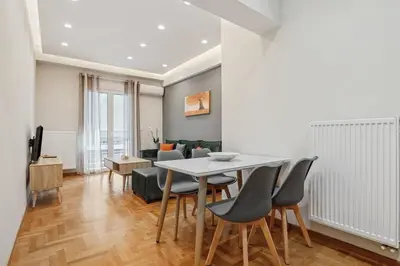 a living room with a white table and chairs at Athene Appartment in Athens