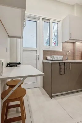 a kitchen with a counter and a table and chairs at Athene Appartment in Athens