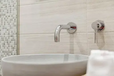 a white sink in a bathroom with a shower at Athene Appartment in Athens