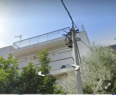 a building with a balcony on top of it at Seaside Resort in Piraeus