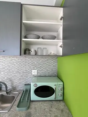 a microwave sitting on a kitchen counter next to a sink at Glyfada Center Front Seaview Studio A in Athens