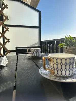 a coffee cup and saucer on a table on a balcony at Glyfada Center Front Seaview Studio A in Athens