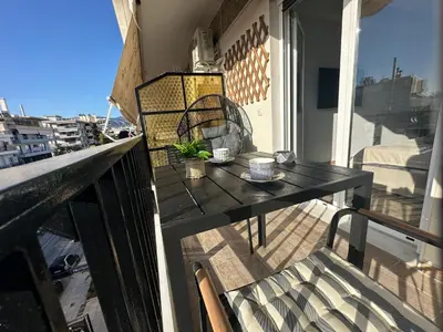 a patio table on a balcony with a view at Glyfada Center Front Seaview Studio A in Athens