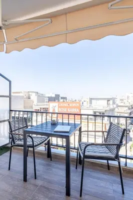 a table and chairs on the roof of a building at Glyfada Center Front Seaview Studio A in Athens