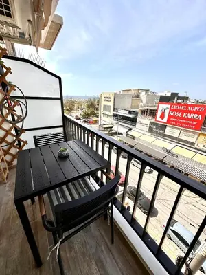 a balcony with a table and a view of a city at Glyfada Center Front Seaview Studio A in Athens