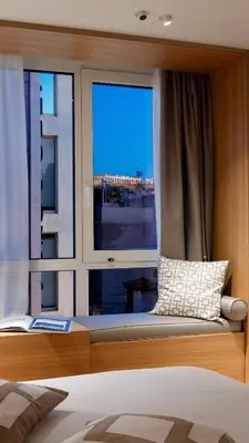 a bedroom with a window with a bed and a pillow at Acropolis View By Ermou in Athens