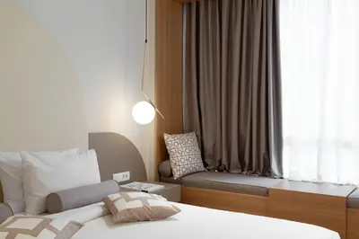 a bedroom with a bed and a couch next to a window at Acropolis View By Ermou in Athens