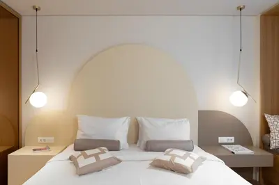 a bedroom with a large white bed with two pillows at Acropolis View By Ermou in Athens
