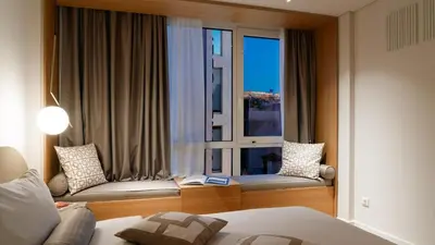 a bedroom with a window with a bed and a couch at Acropolis View By Ermou in Athens