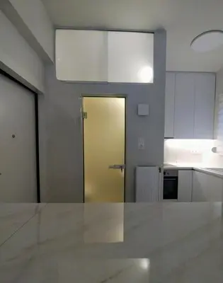 a kitchen with a yellow door in a room at AMG Kalimarmaro Small Apartment in Pagkrati Close to Metro in Athens