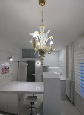 a kitchen with a chandelier hanging from a ceiling at AMG Kalimarmaro Small Apartment in Pagkrati Close to Metro in Athens