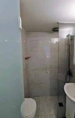 a bathroom with a shower and a toilet and a sink at AMG Kalimarmaro Small Apartment in Pagkrati Close to Metro in Athens