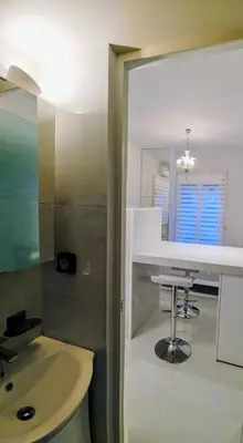 a bathroom with a sink and a mirror at AMG Kalimarmaro Small Apartment in Pagkrati Close to Metro in Athens