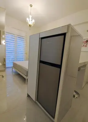 a large glass door in a room with a bed at AMG Kalimarmaro Small Apartment in Pagkrati Close to Metro in Athens