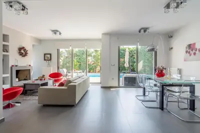 a living room with a couch and a table at Luxury modern villa with swimming pool, Athens Riviera in Lagonissi