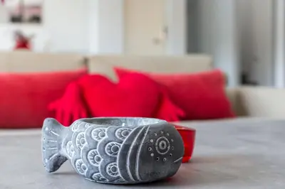 a glass tea pot sitting on a table with a red couch at Luxury modern villa with swimming pool, Athens Riviera in Lagonissi