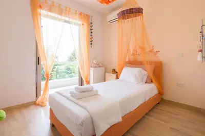 a bedroom with a bed and a large window at Luxury modern villa with swimming pool, Athens Riviera in Lagonissi