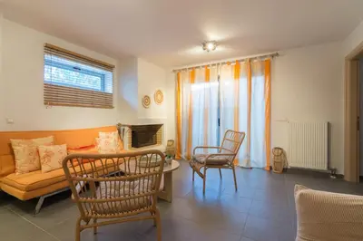 a living room with a couch and a table and chairs at Luxury modern villa with swimming pool, Athens Riviera in Lagonissi