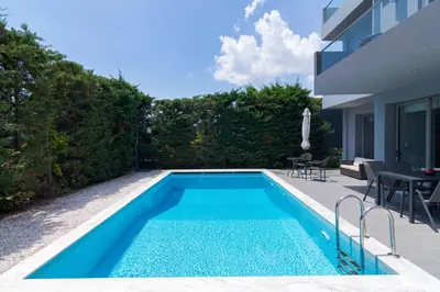 a swimming pool in the backyard of a house at Luxury modern villa with swimming pool, Athens Riviera in Lagonissi